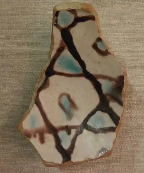 A piece of a bowl with a star of David design